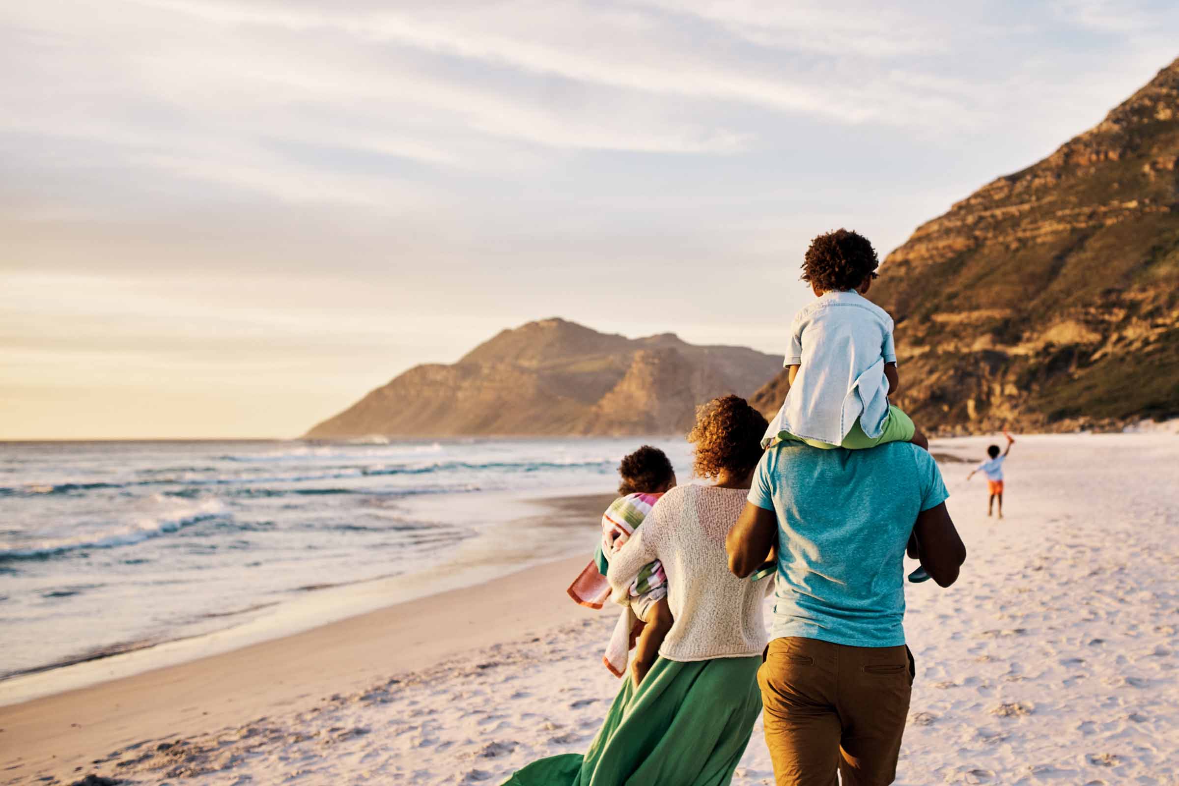 A family walking on a beach.