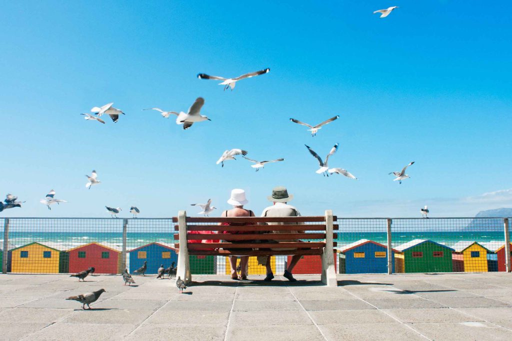 A senior couple enjoy lunch at Muizenberg Beach in Cape Town.