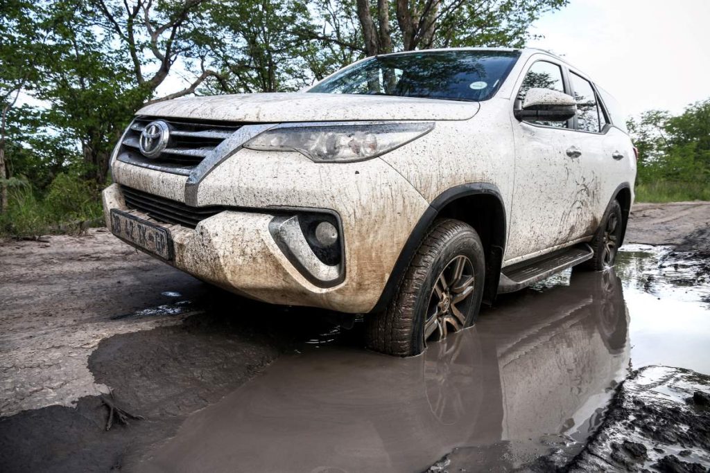 A Toyota Fortuner 4x4 wades through water in South Africa.