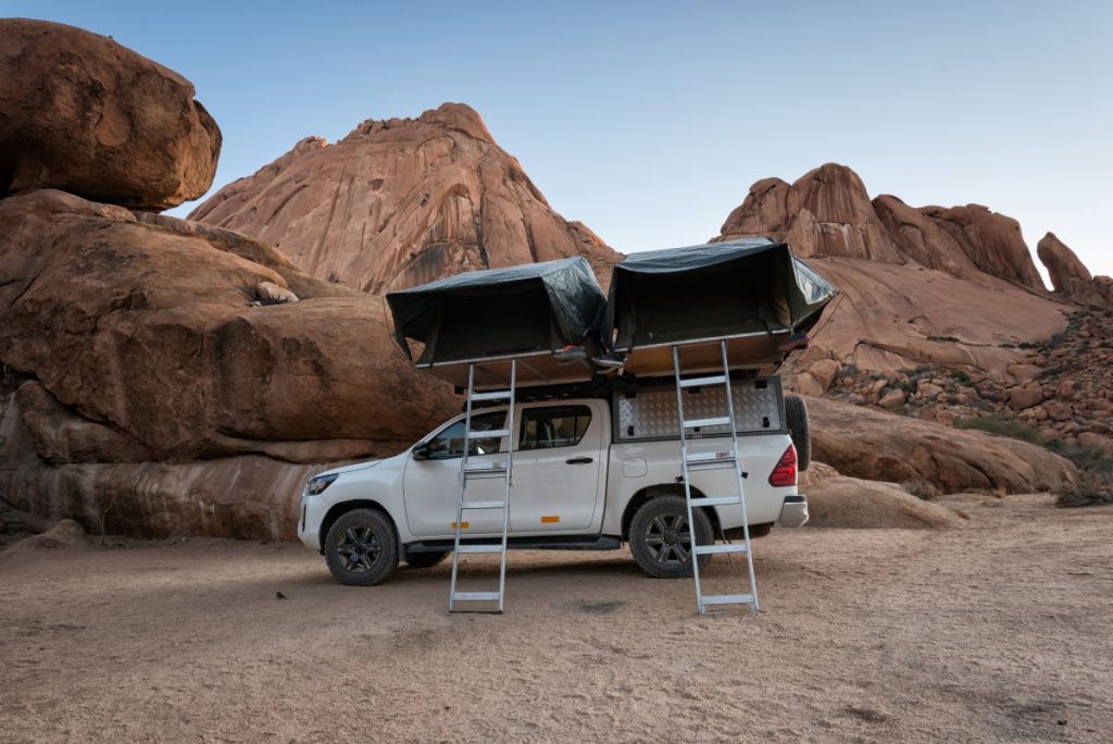 A Toyota Hilux with two rooftop tents.