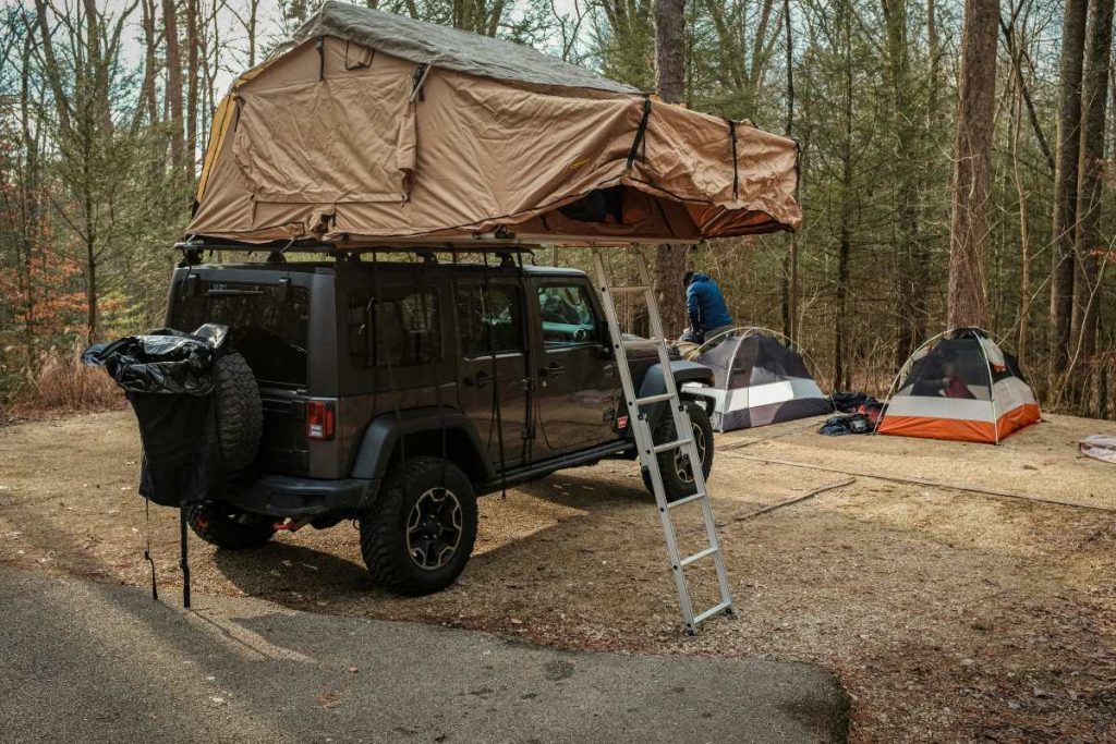 A Jeep Wrangler 4x4 with a rooftop tent.