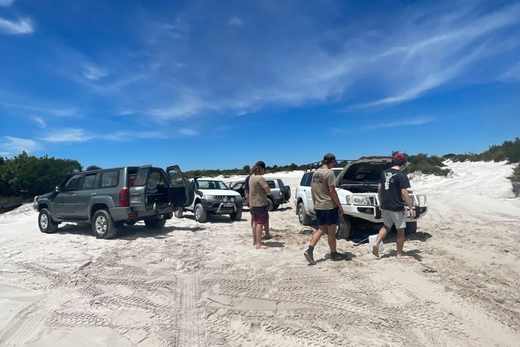 Members of a 4x4 forum with their Nissan Patrol vehicles.