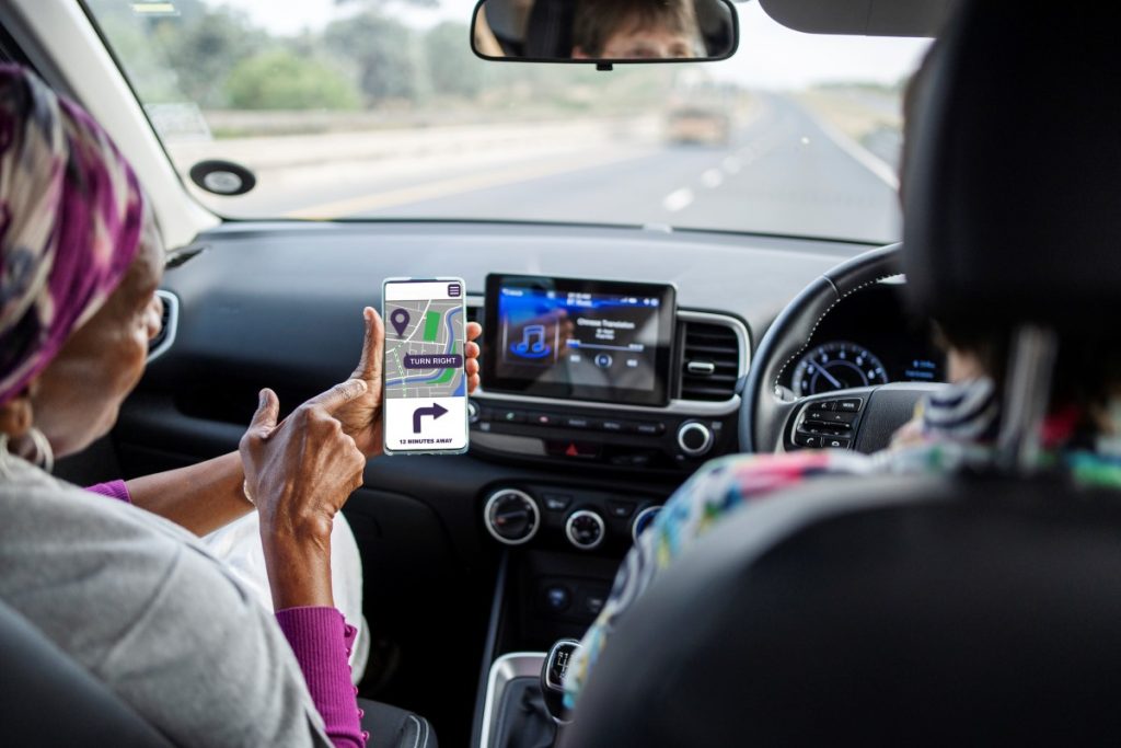 Two elderly women follow directions in a car.