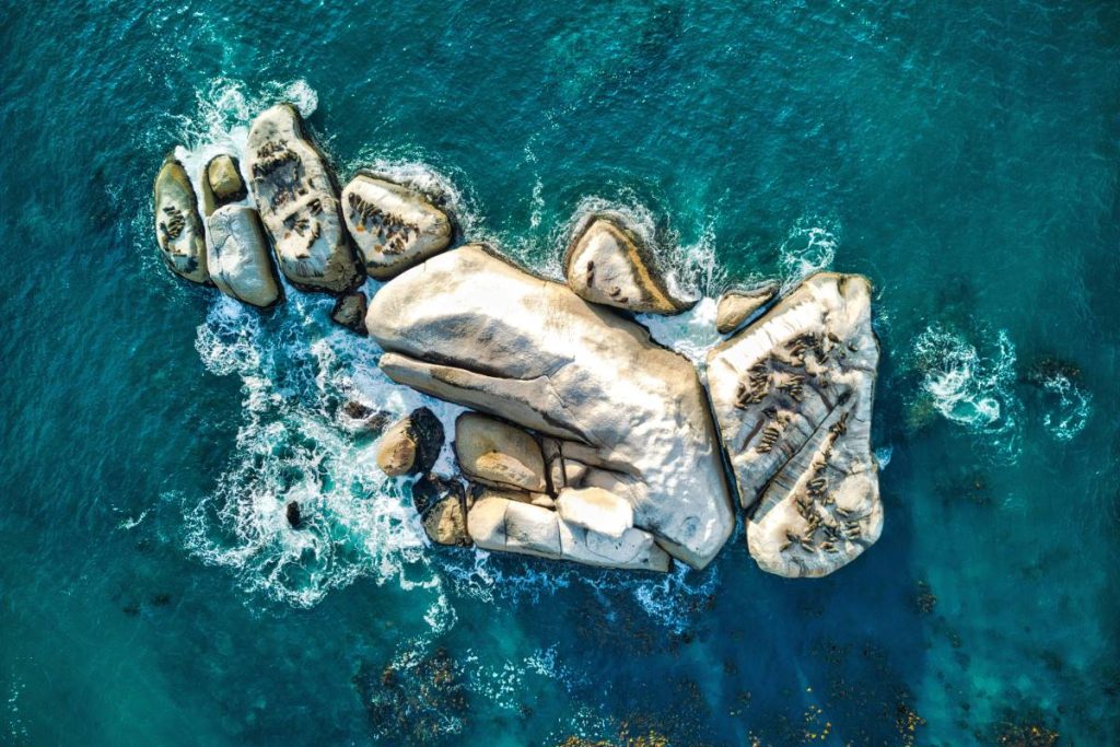 A drone shot of a rock in the Atlantic Ocean.