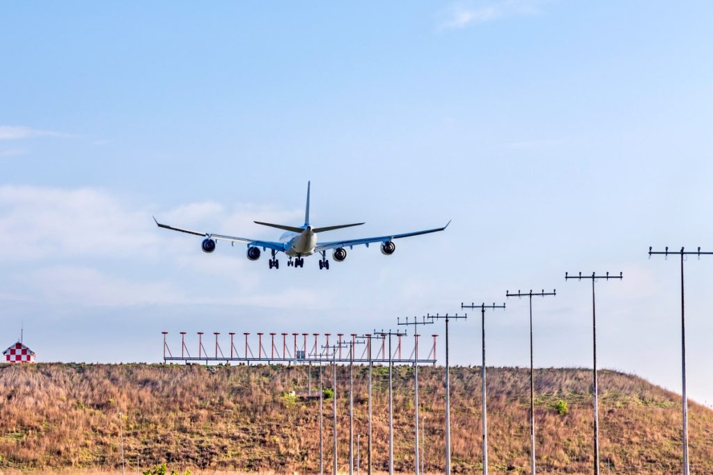 A plane lands at OR Tambo International Airport.