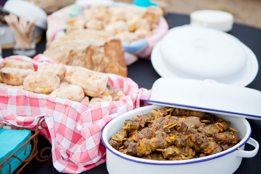 Fresh roasted bread and mutton kebabs in dishes on a table.