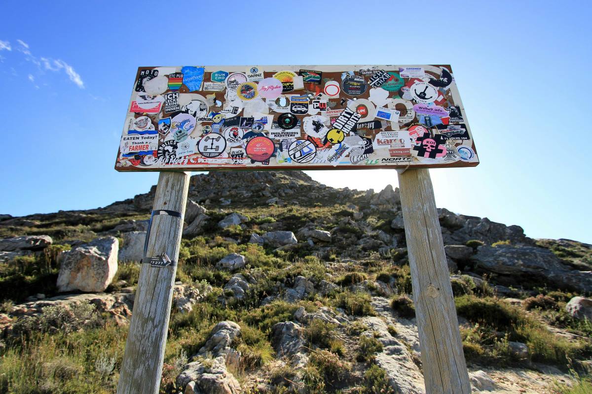 A sticker covered sign on the Swartberg Pass.