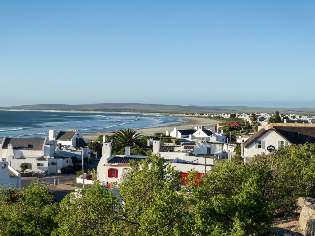Aerial view of the whitewashed beach houses and coastline of Paternoster, South Africa.