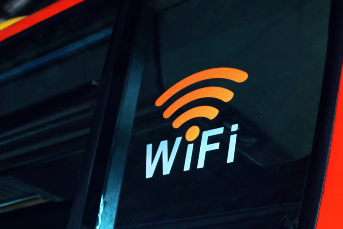 A Wi-Fi sign on the side of a public bus.