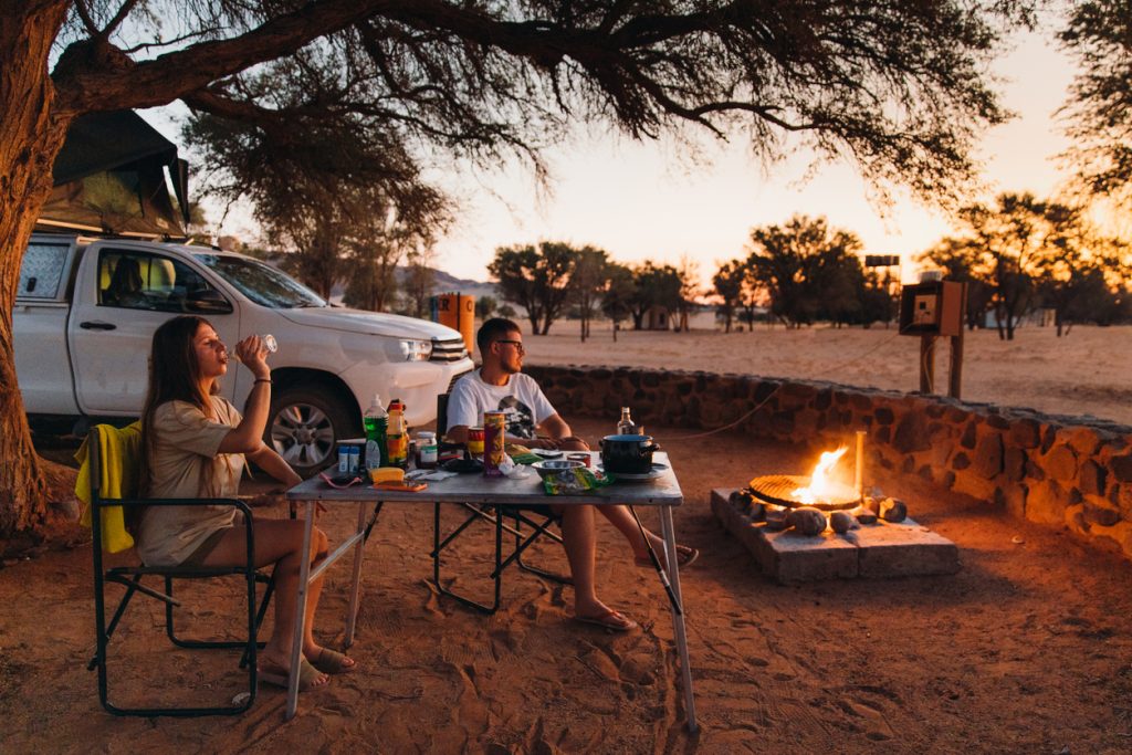 Young couple camping in Namibia on a self-drive holiday.