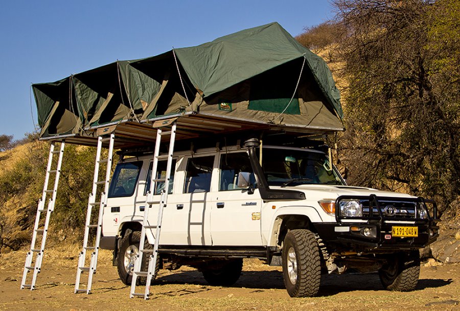 The Land Cruiser HJ 76 4x4 rental with three rooftop tents.