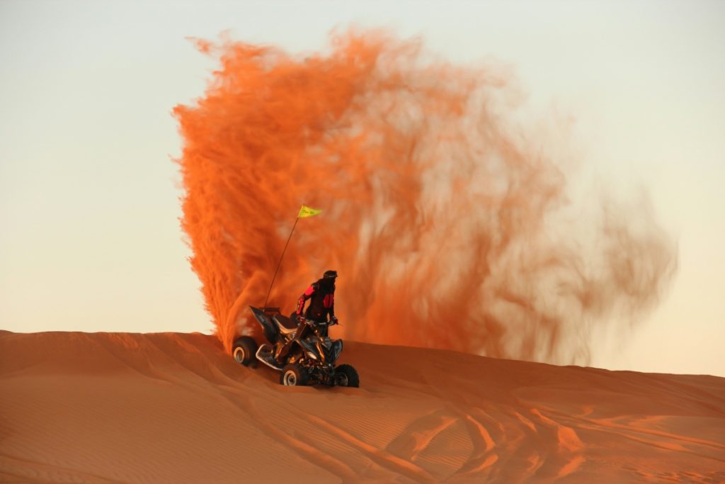 Quad biking on a red sand dune in the Namib Desert.