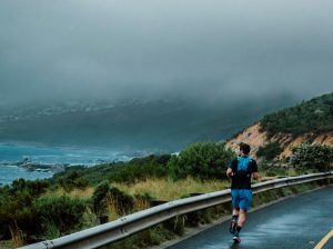 A runner jogs along the coastline in Cape Town, South Africa.