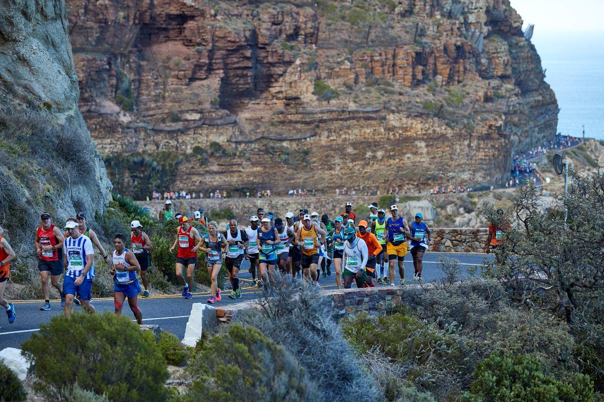 Runners pass along Chapmans Peak Drive during the Two Oceans Marathon.