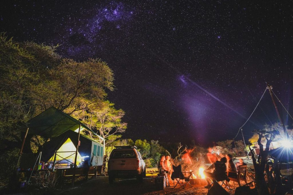 People camping in Namibia at night.