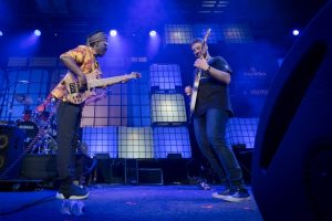 Two guitarists at a music festival.