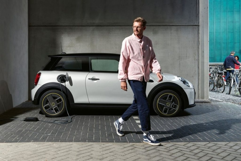 A white MINI Cooper SE charging.