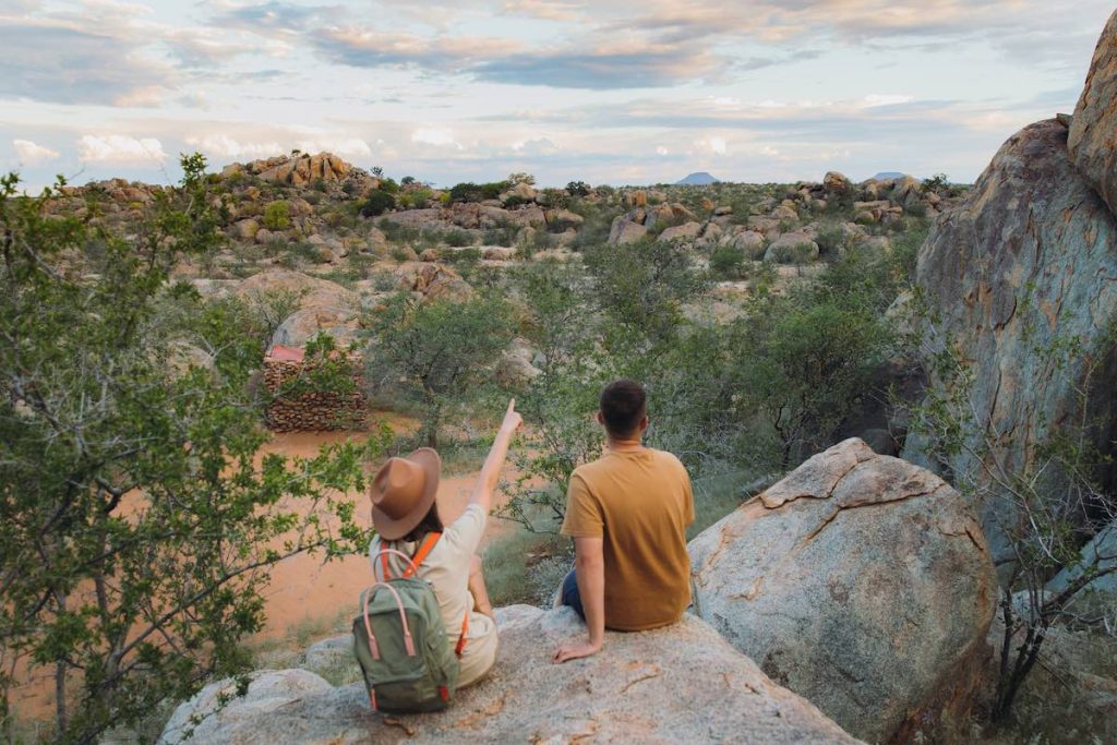A young couple on a hike on a Namibian honeymoon.
