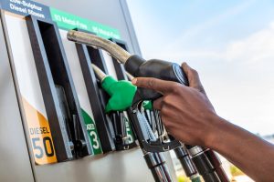 A petrol attendant grabs a fuel pump in South Africa.