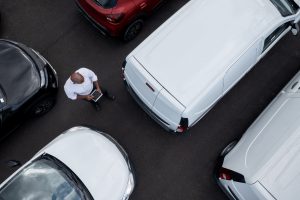 A car rental worker inspects the vehicle fleet.