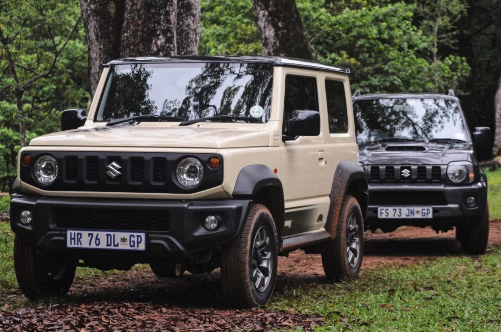 Two Suzuki Jimnys on a trail.