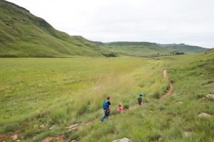 A family walks through the Drakensberg.