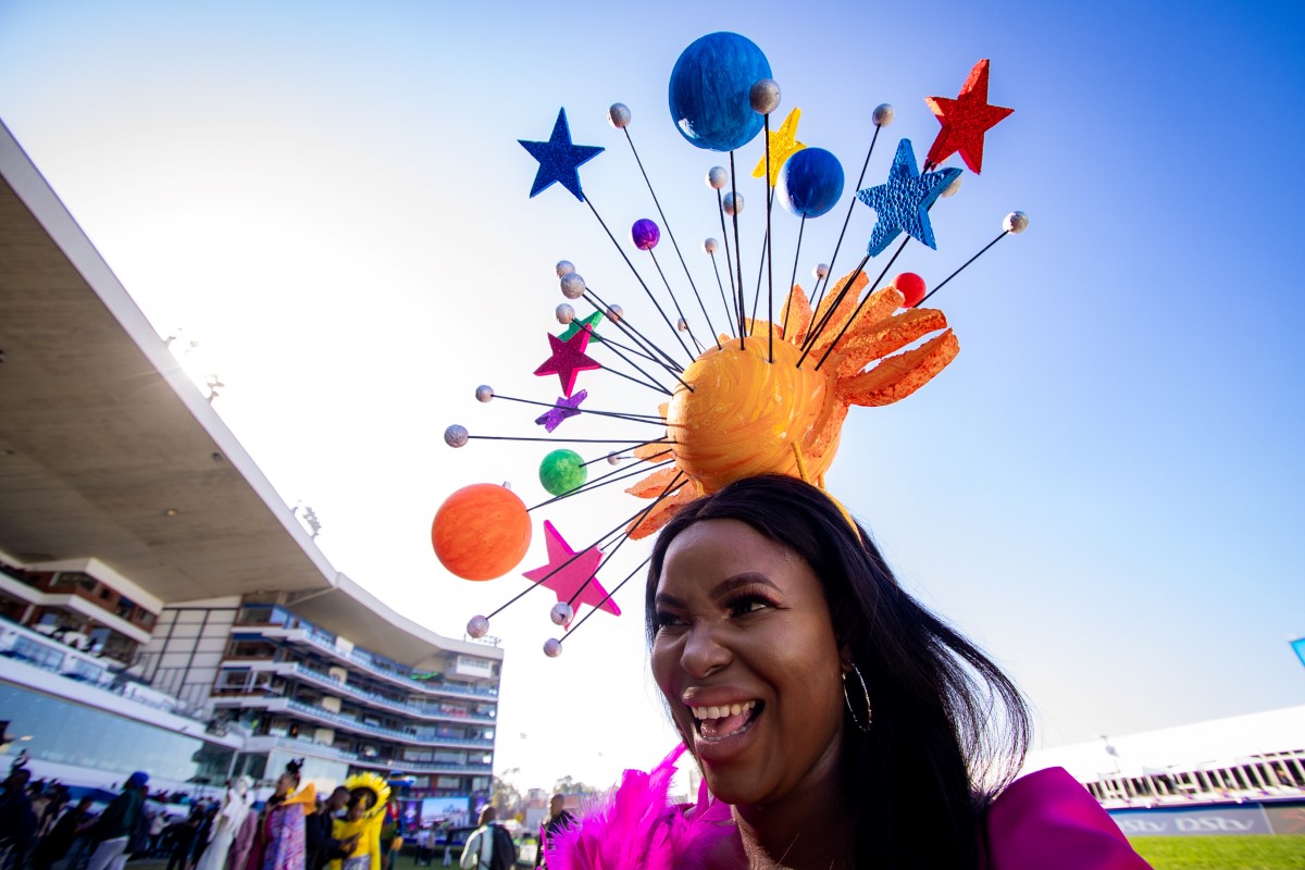 Crazy headwear on a woman at a horse race.