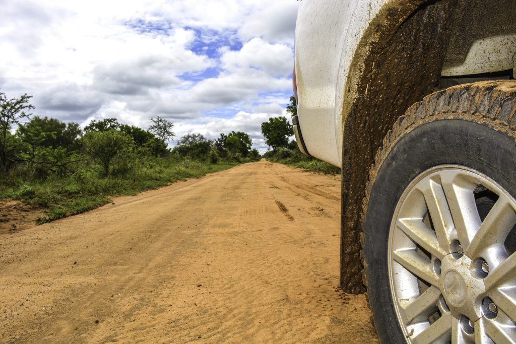 Ground level photo of a 4x4's wheel on a muddy road. Photo: Getty Images