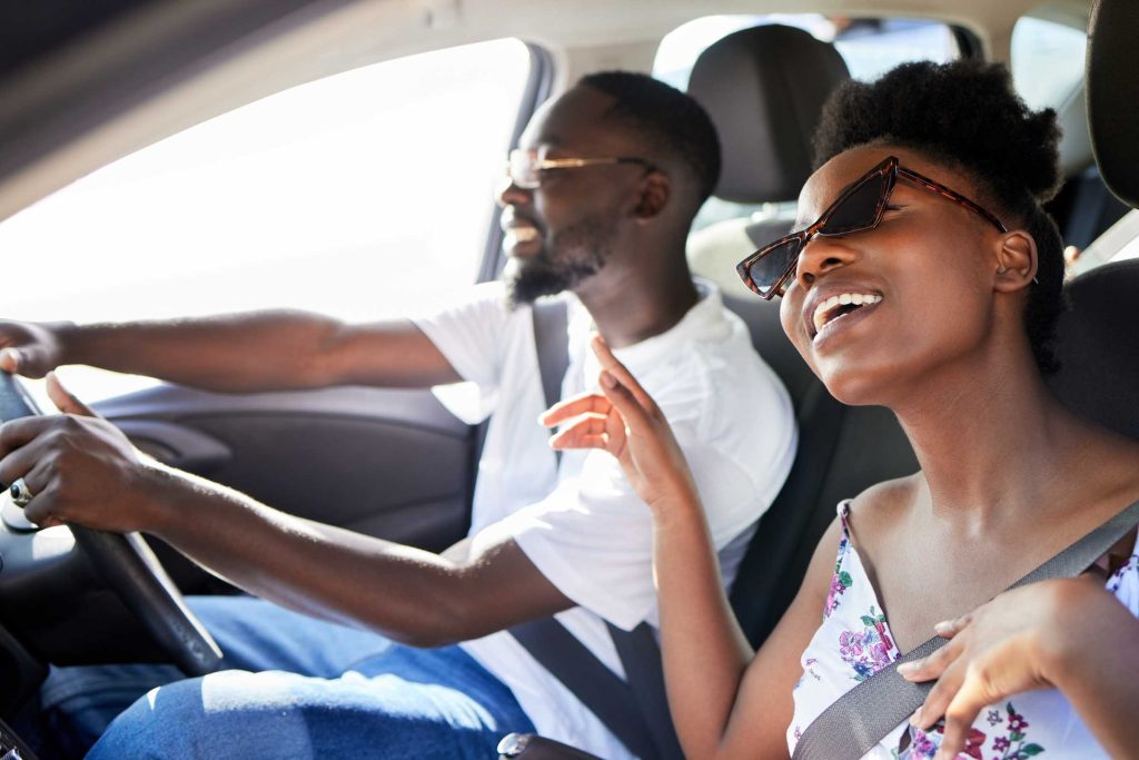 Couple singing while driving.