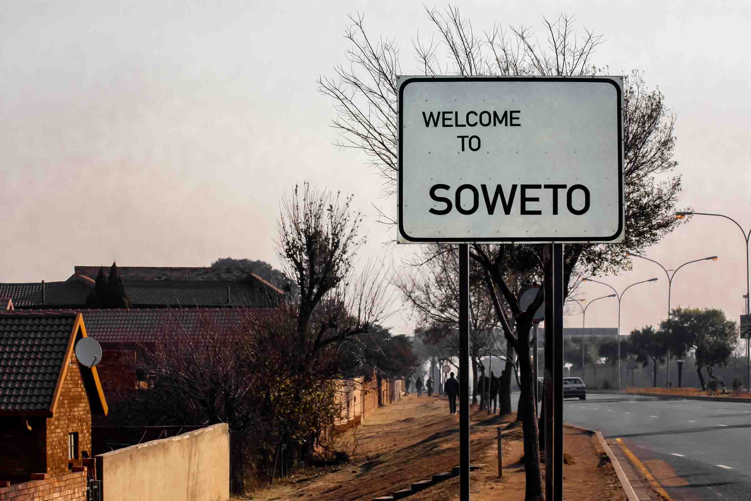 Welcome to SOWETO - banner or road sign at the entrance of Soweto, in the suburb of Johannesburg. Greeting on the information road sign at the entrance to Soweto.