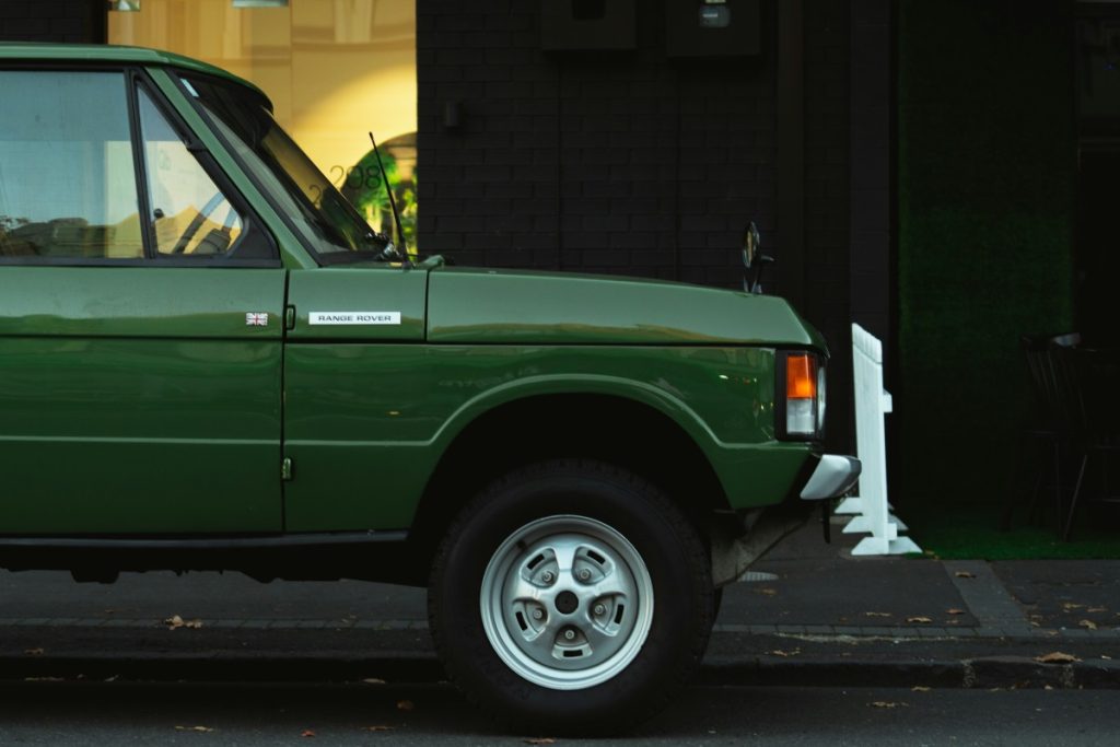 The side profile of a green Range Rover.