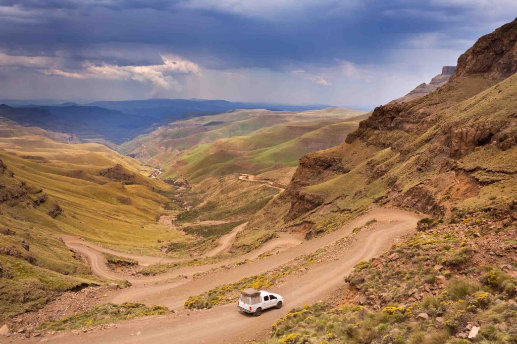 A car driving the hairpin turns of the Sani Pass on the border of South Africa and Lesotho.