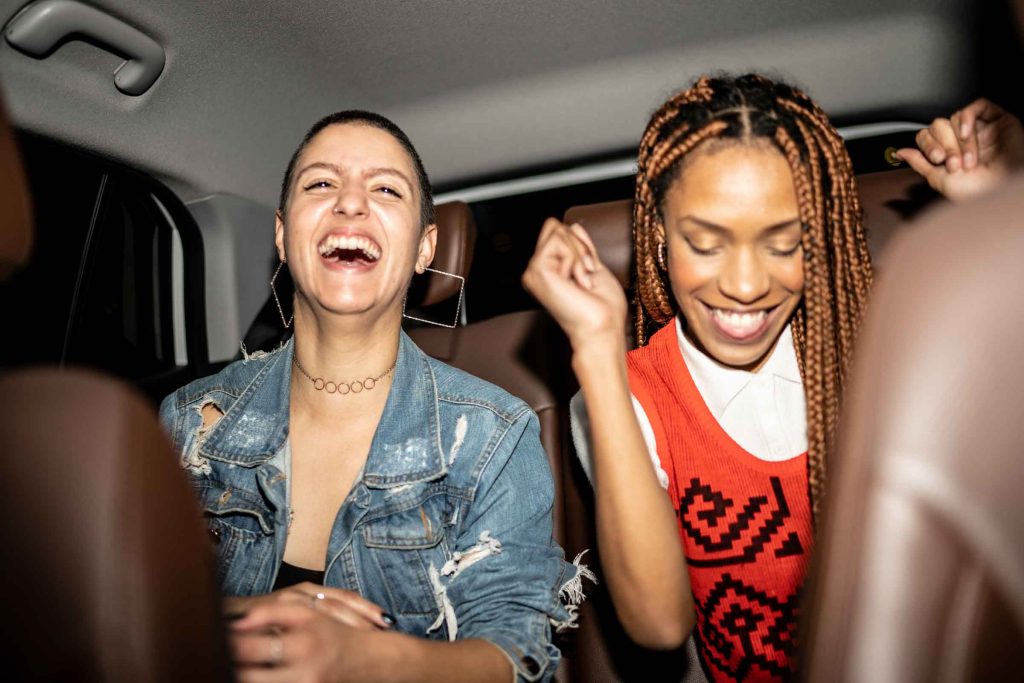 Friends singing in the car.