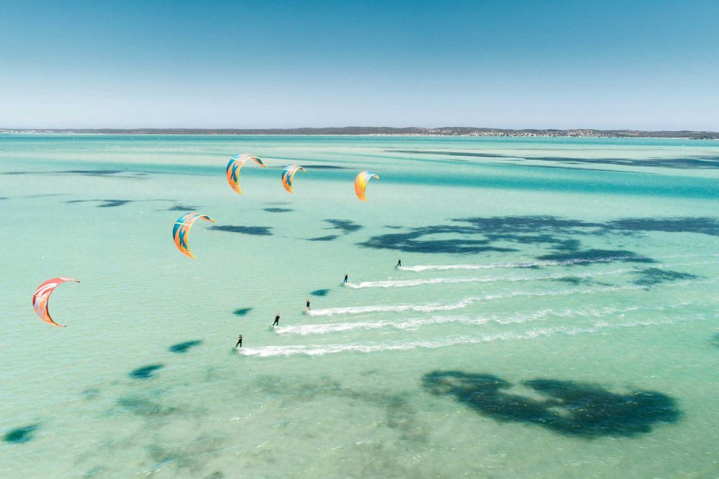 Kite surfers riding in formation at West Coast National Park.