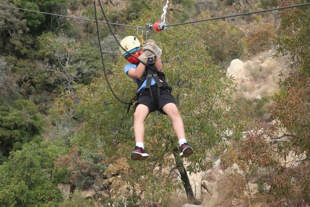 A child ziplines at Hartebeespoort Dam.