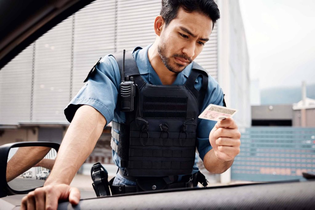 A police officer checks a drivers license.