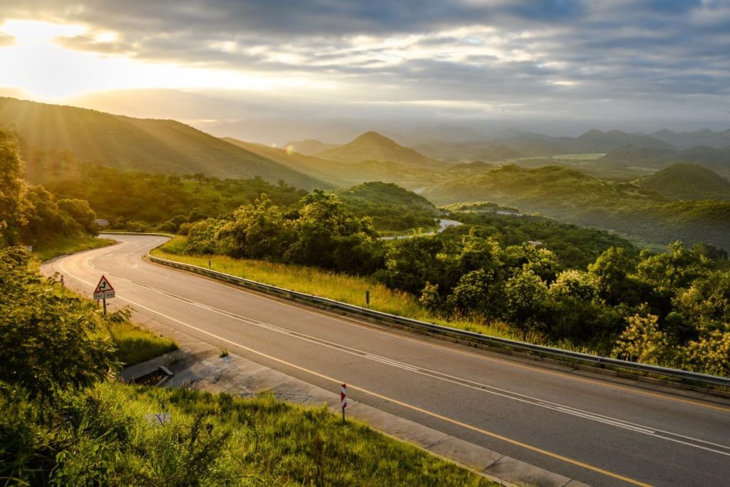 A beautiful winding road with greenery.