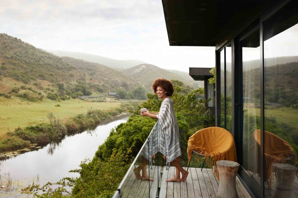 A woman with an afro at a safari lodge.