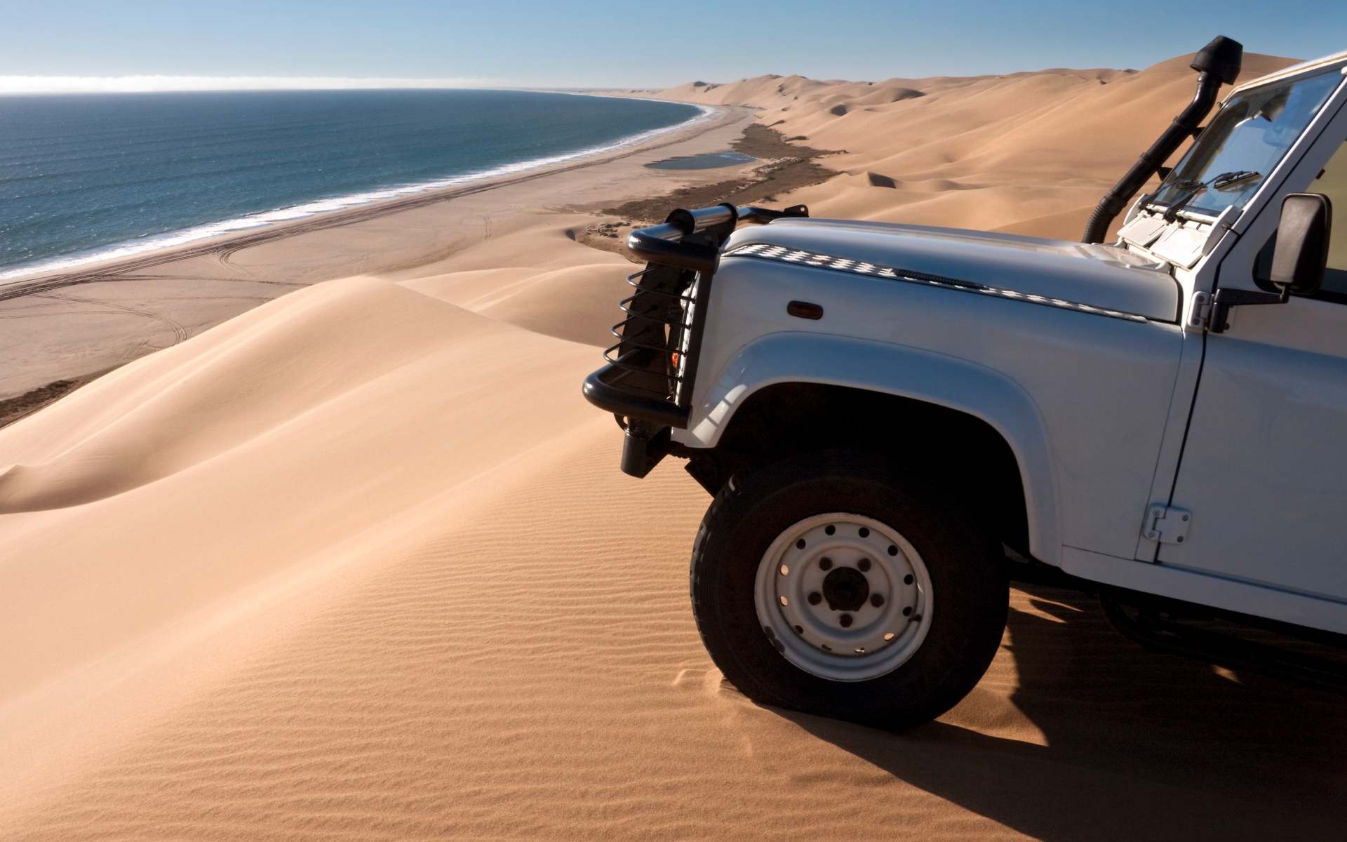 Driving through the Namib Desert, Namibia | Photo: SteveAllenPhoto via Getty