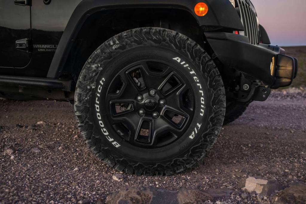 A 4x4 wheel on a gravel road.