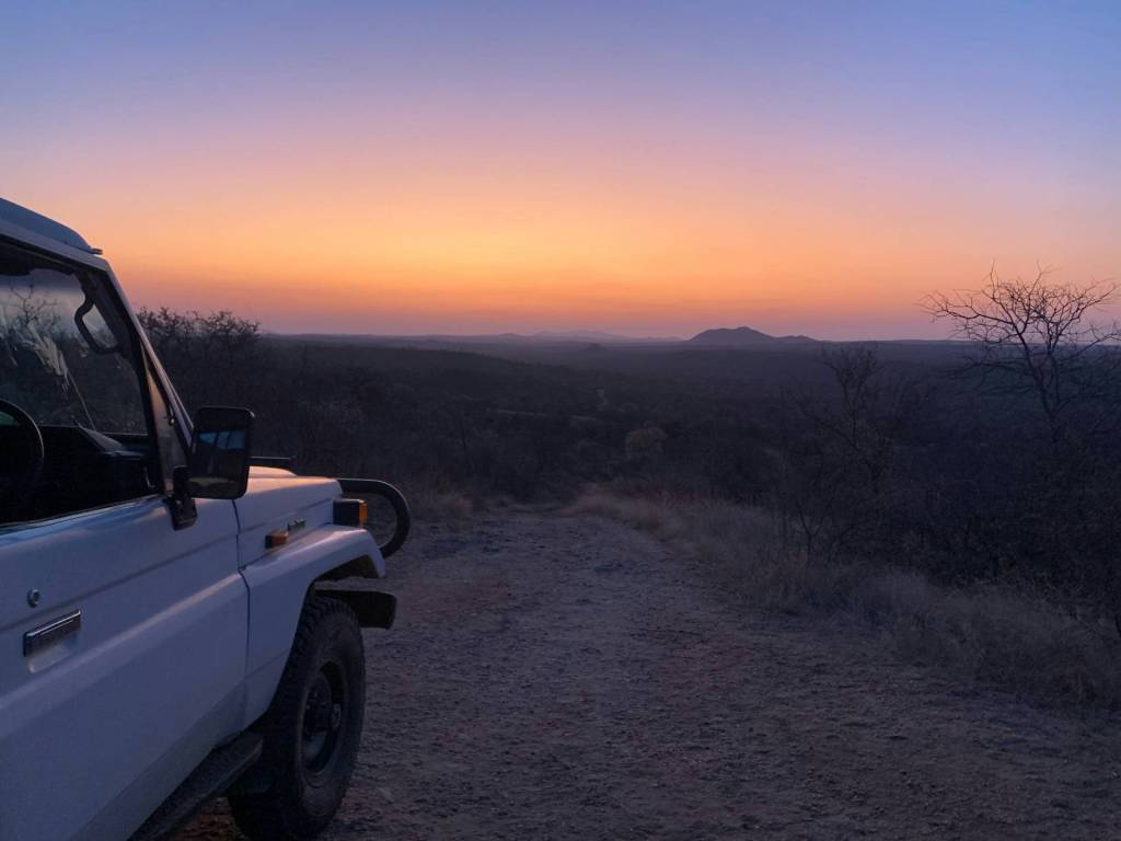 4x4 vehicle on a dirt road at sunset