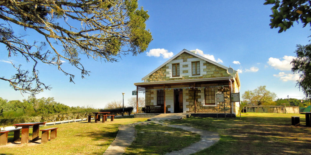 Exterior view of the Diepwalle Tea House located in a historic forester house in Knysna Forest, South Africa.