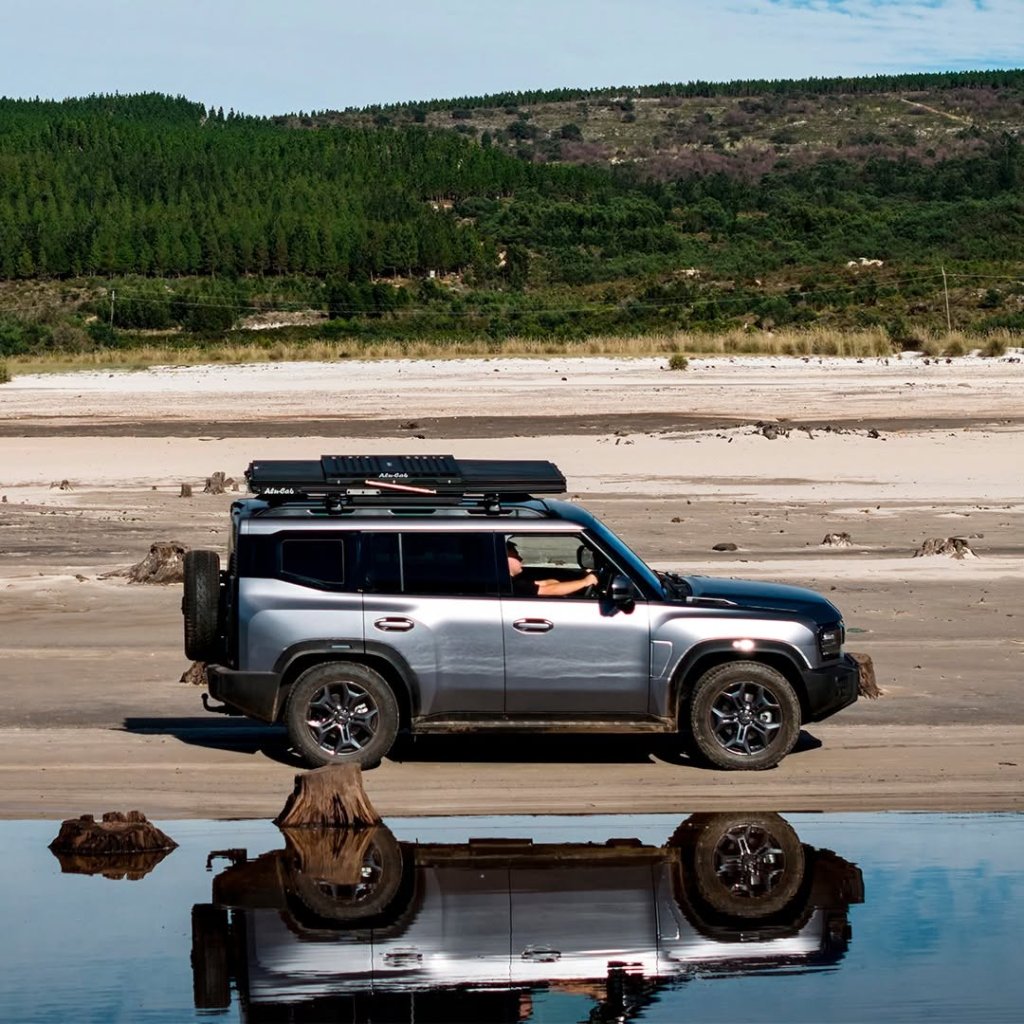 The Jetour T2 driving along a river bank.