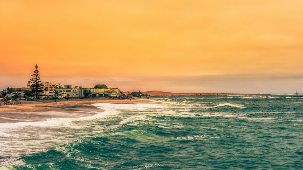 View of Swakopmund in the evening light with the coastline and waves.