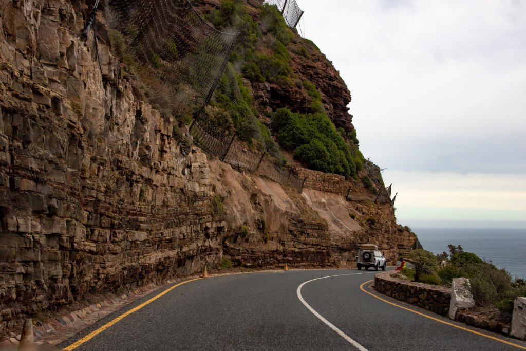 A 4x4 driving along a winding mountain road in South Africa.