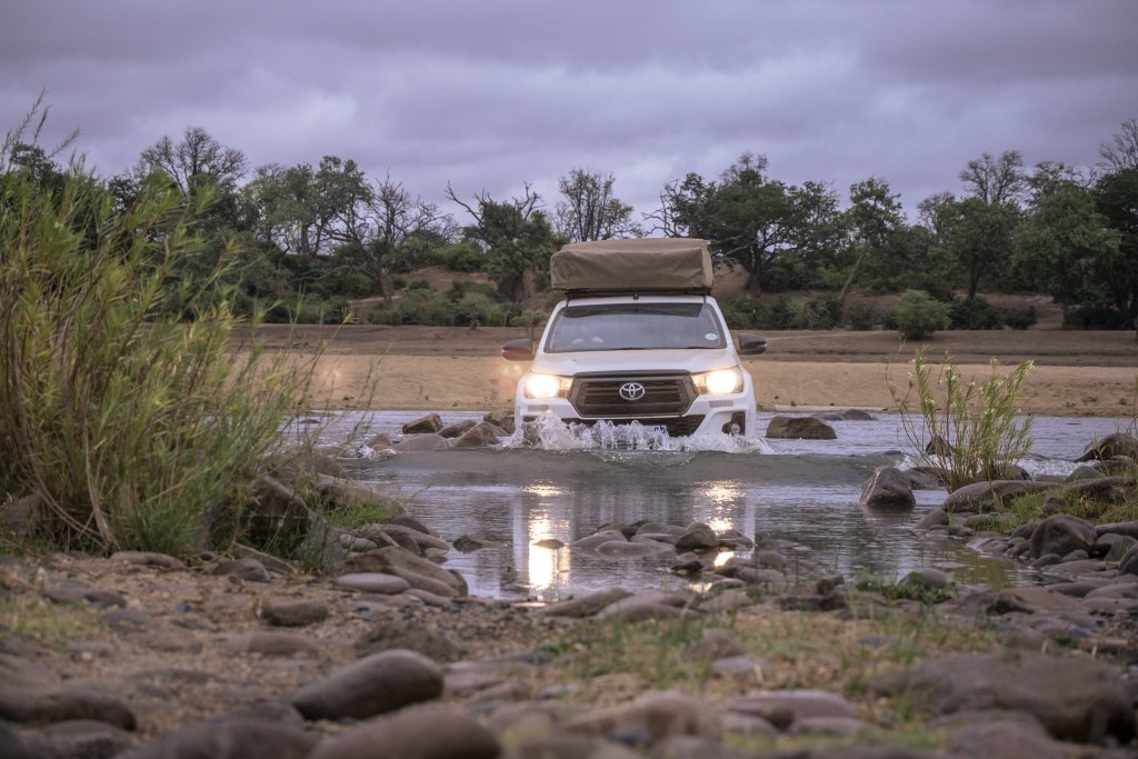 A 4x4 crossing a river in